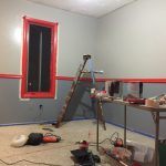 Painting in progress Painting in progress with cans, brushes, laddrers and tools around the room.