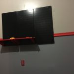 Red shelves with black rack in mid assembly. Reminiscient of the control areas of Engineering on Star Trek TOS Red shelves with black rack going up