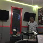 Screens, lights, photos and shelves going up! Connie setting pu shelves above my desk with the 2 viewscreens on the walls