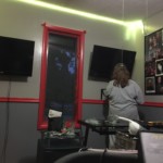 Screens, lights, photos and shelves going up! Connie setting pu shelves above my desk with the 2 viewscreens on the walls