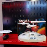 More Enterprises A 25th anniversary Enterprise D and a TOS Enterprise alarm clock with SFX on one of the red shelves