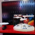 More Enterprises A 25th anniversary Enterprise D and a TOS Enterprise alarm clock with SFX on one of the red shelves