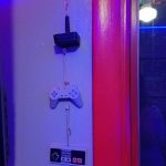 Retro controllers Three ornaments hang next to the window: Atari, Playstation 1, and NES controllers