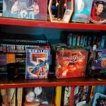 Star Trek and Babylon 5 books and sci fi knicknacks The Star Trek and Babylon 5 books are fronted by plates, photos, B5 card game cards, a D7 cruiser, family photos and other memorabilia.