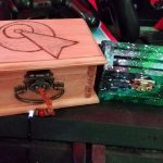 Treasure boxes A wooden box decorated in the Vulcan IDIC symbol and a green, space theme painted treasure chest sit on the PS4