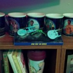 Star Trek mugs Collection of TOS Star Trek mugs atop a bookshelf. Other books and pictures of my son in view.