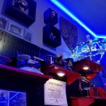 The East wall with shelving, lights, and memorabilia on wall including a lit up DS9, Picard garden gnome, SHIELD items and a certificate for donating to the New Starship Foundation. East wall with shelving, lights, and memorabilia on wall